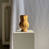 Large antique handmade ochre yellow jug with a pink flower pattern.