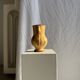 Large antique handmade ochre yellow jug with a pink flower pattern.