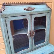 Blue patinated wooden display cabinet