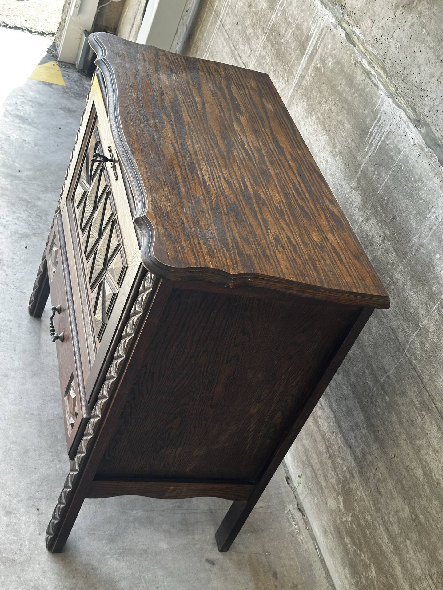 Small storage cabinet in carved oak – circa 1930