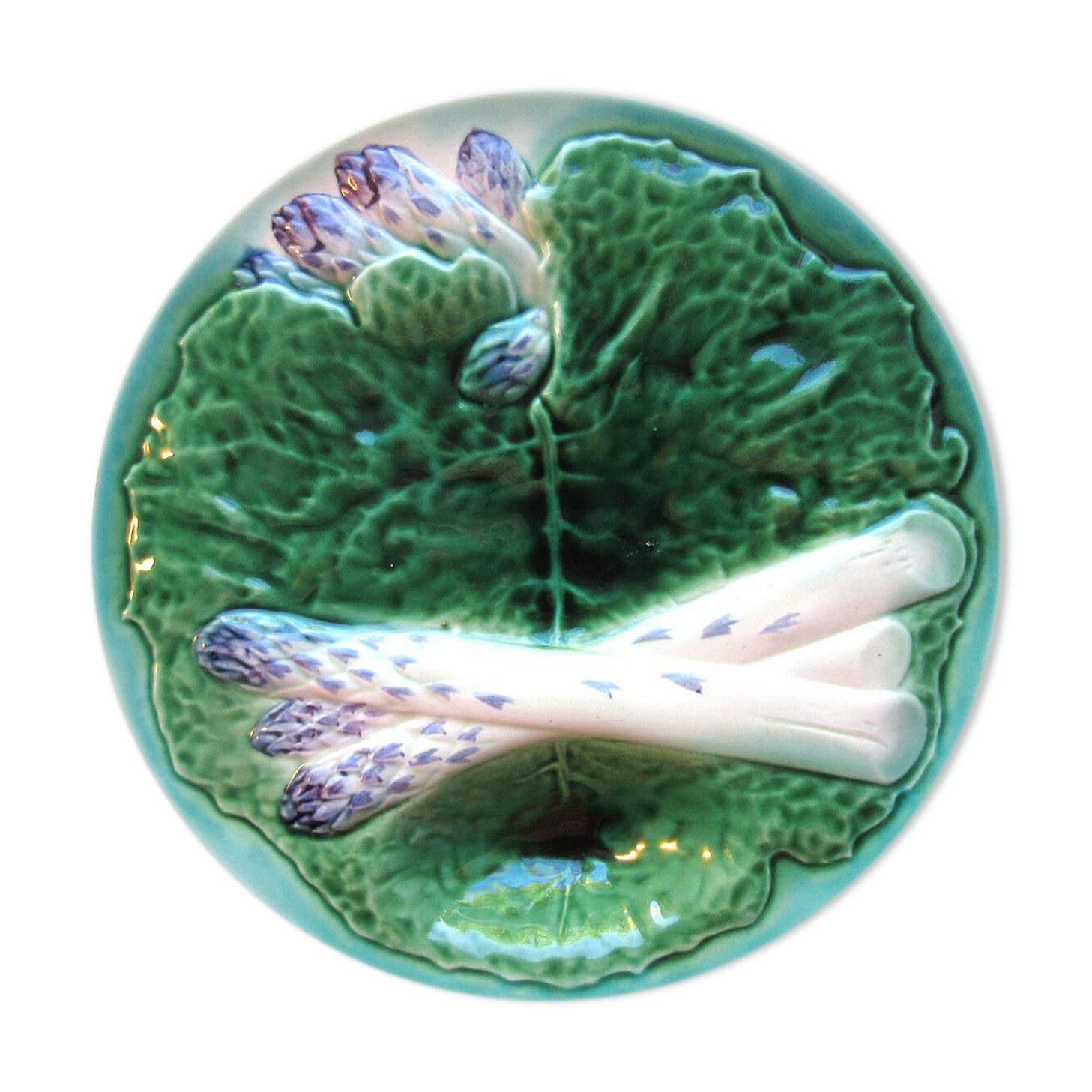 Asparagus plate in dabbling, with a leaf of green cabbage