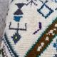 Berber floor pouf: Handwoven Moroccan wool cushion.