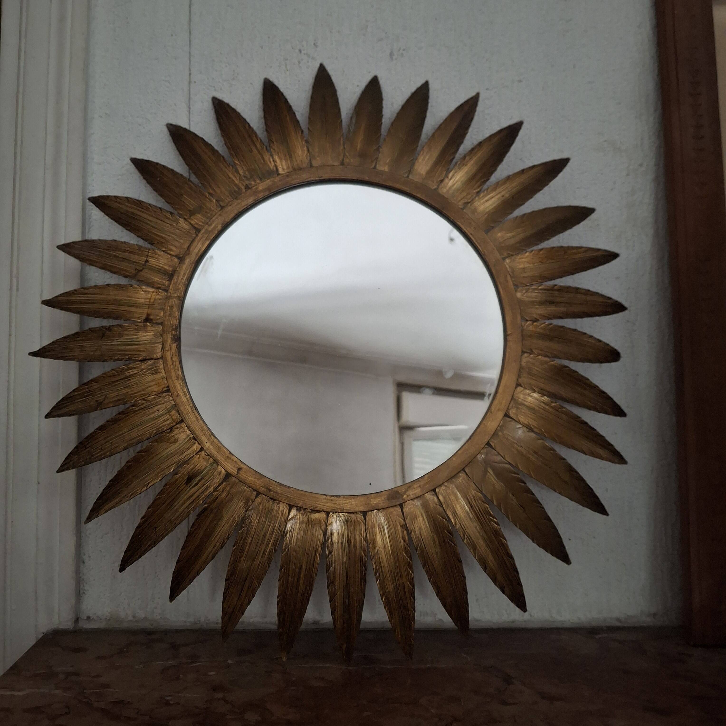 Large sun mirror in gilded metal. 1960