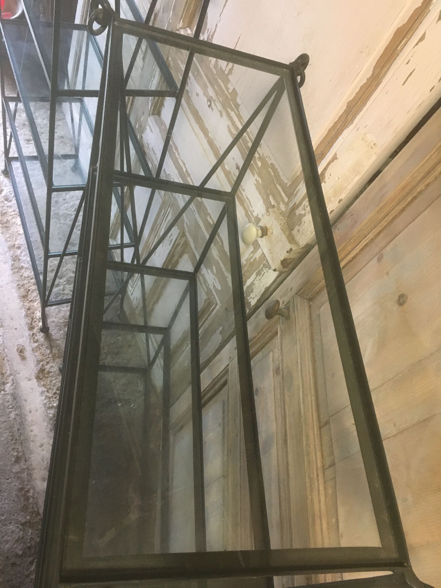 Pair of wrought iron and glass bookshelf shelves.