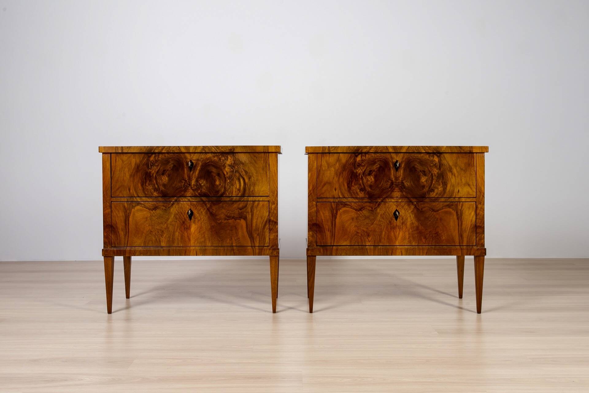 Elegant pair of Biedermeier style walnut commodes, Germany, French polish.