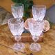 Cut crystal white wine glasses with a slender baluster-shaped stem.