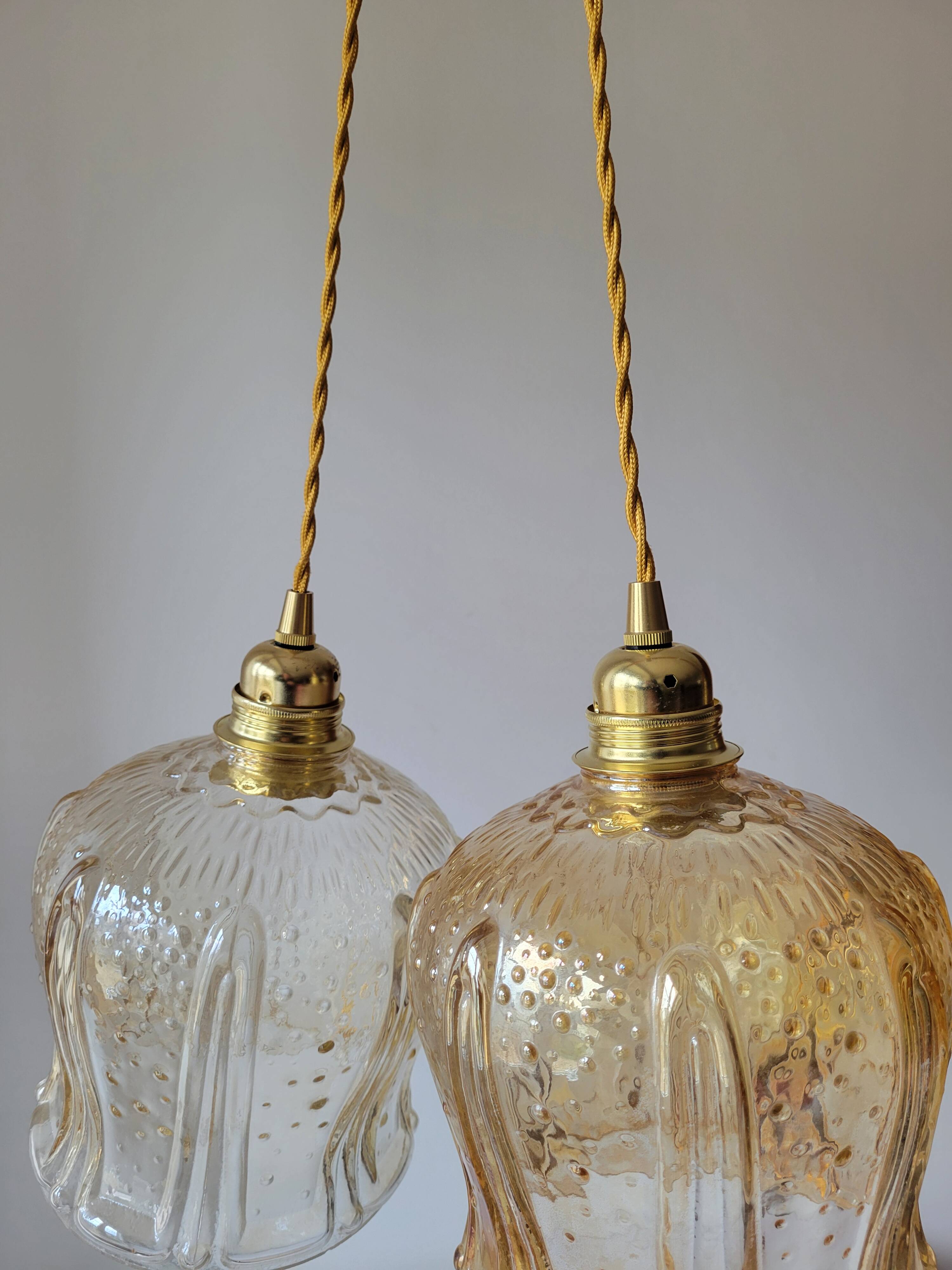 Trio of amber glass pendant lights