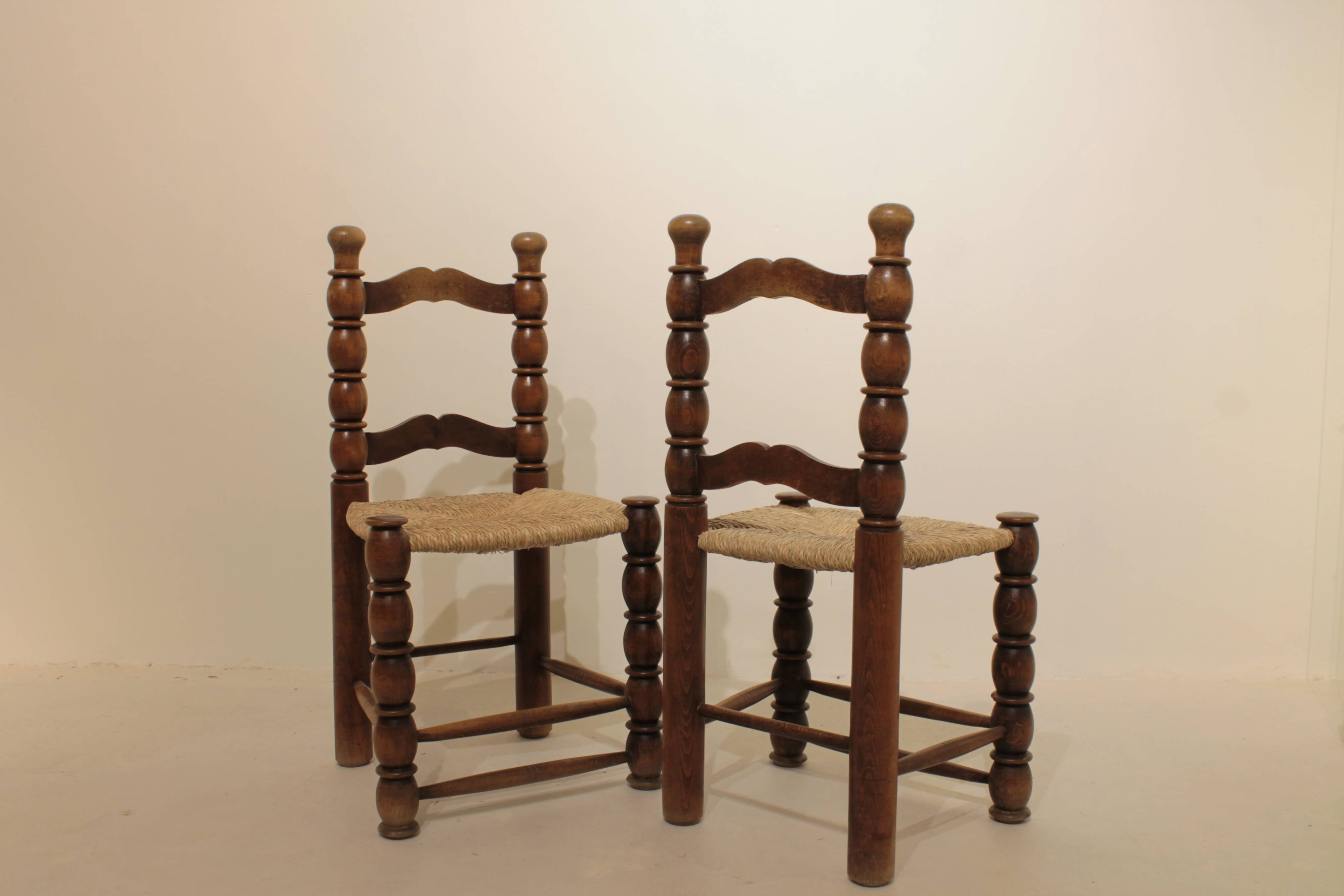 Pair of rustic chairs in turned wood with straw seats