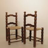 Pair of rustic chairs in turned wood with straw seats