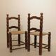 Pair of rustic chairs in turned wood with straw seats