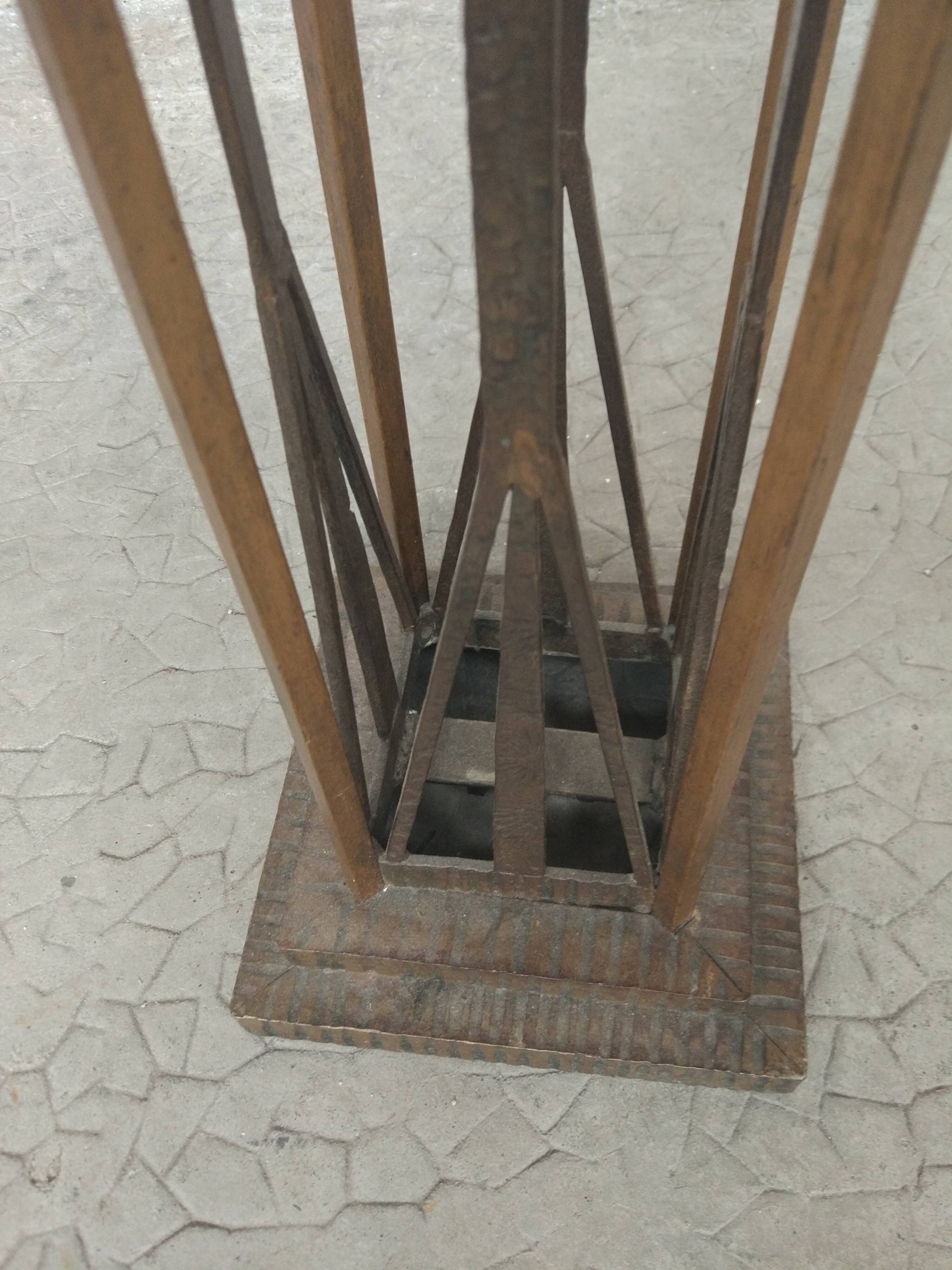 Column 1930 with one foot in wrought iron