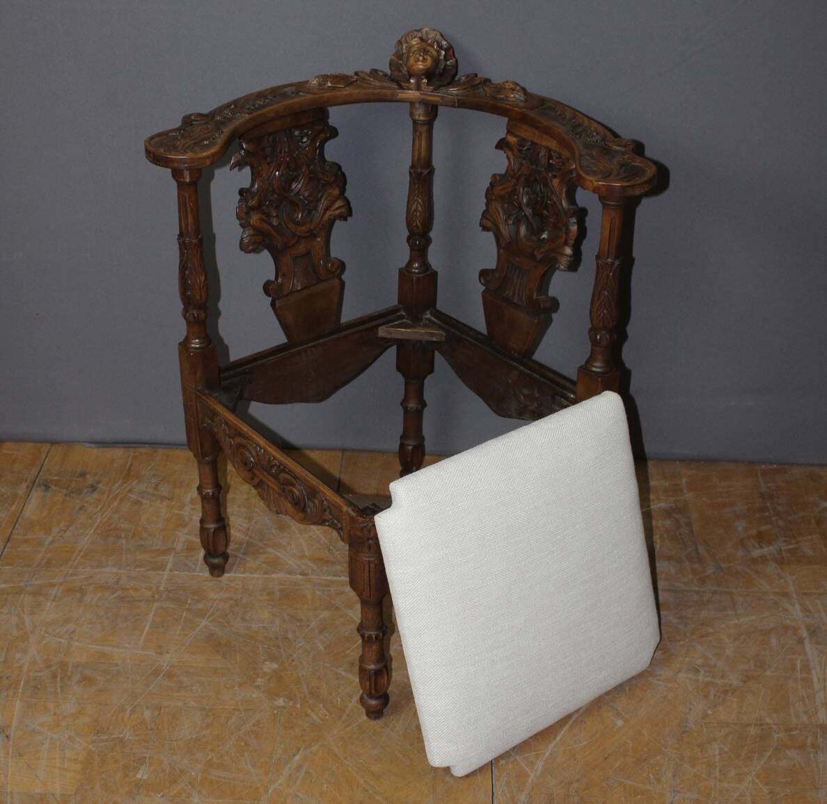 19th century walnut corner armchair with carved angel decoration