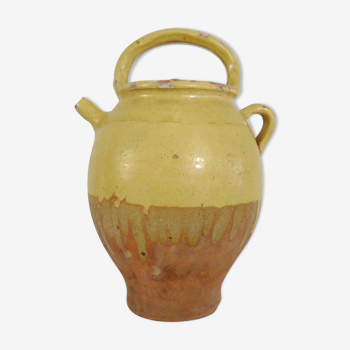 Old jug, chevrette, water pitcher in glazed yellow sandstone. Early twentieth century
