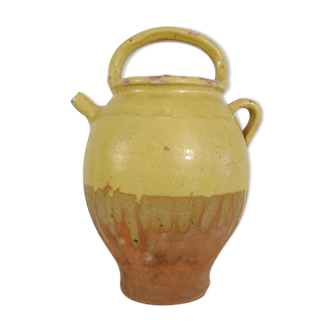 Old jug, chevrette, water pitcher in glazed yellow sandstone. Early twentieth century