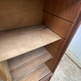 Oak two-column filing cabinet with curtains.