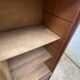 Oak two-column filing cabinet with curtains.