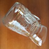Old glass water pitcher with white flowers in relief with gold edging