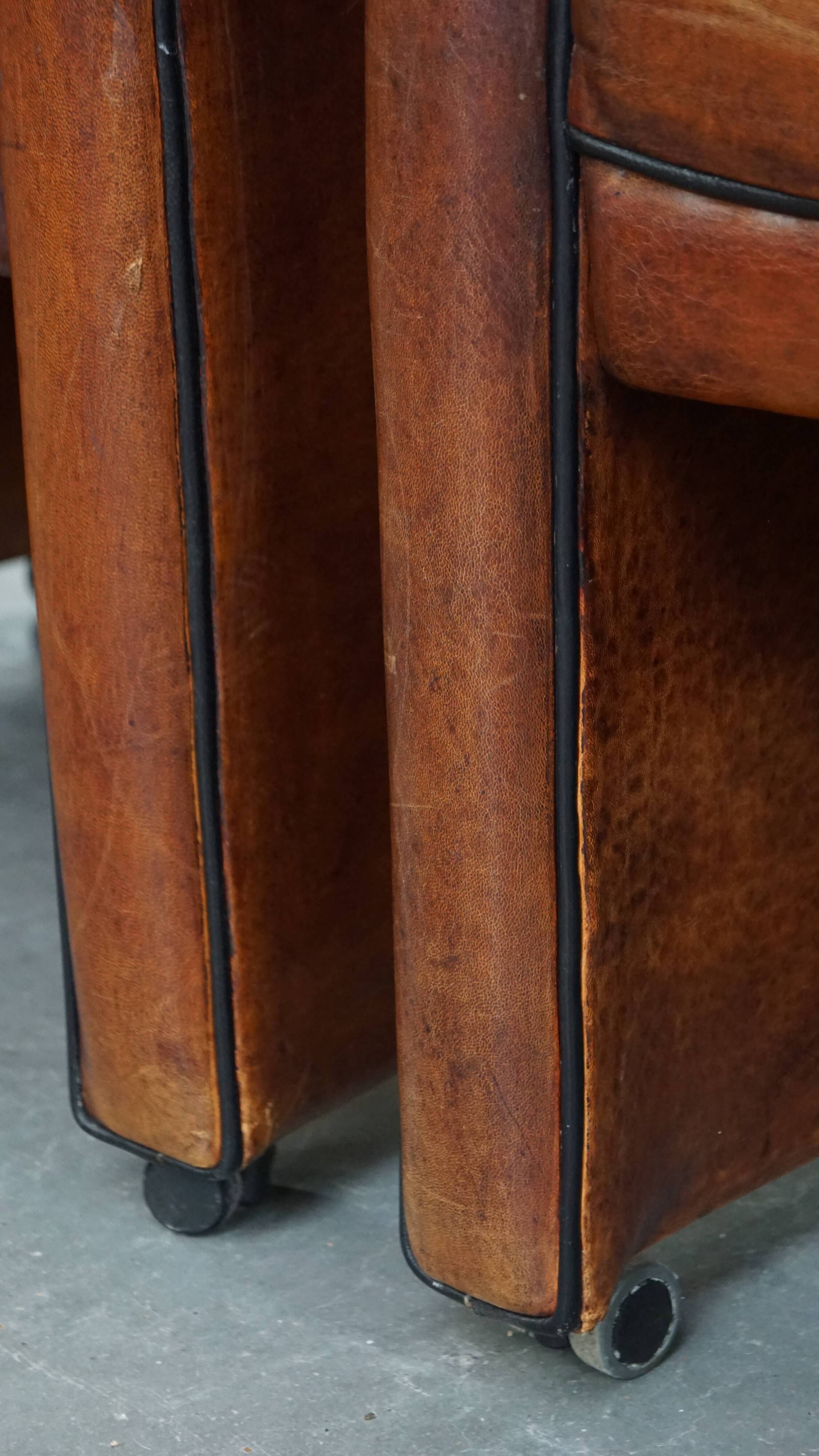 Vintage set of 4 sheepskin leather dining chairs on castors