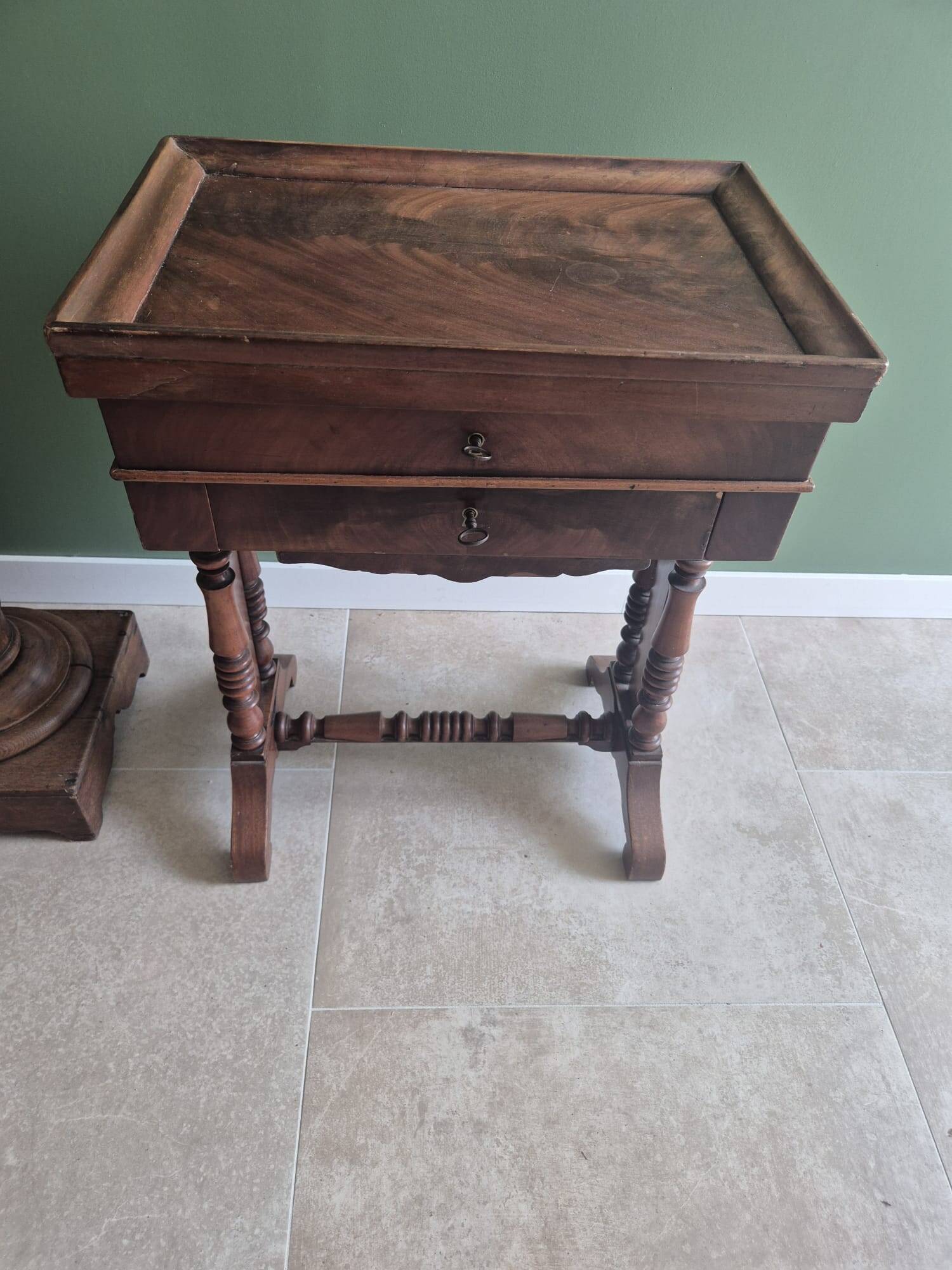 Antique wooden sewing cabinet with mirror and storage.