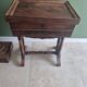 Antique wooden sewing cabinet with mirror and storage.