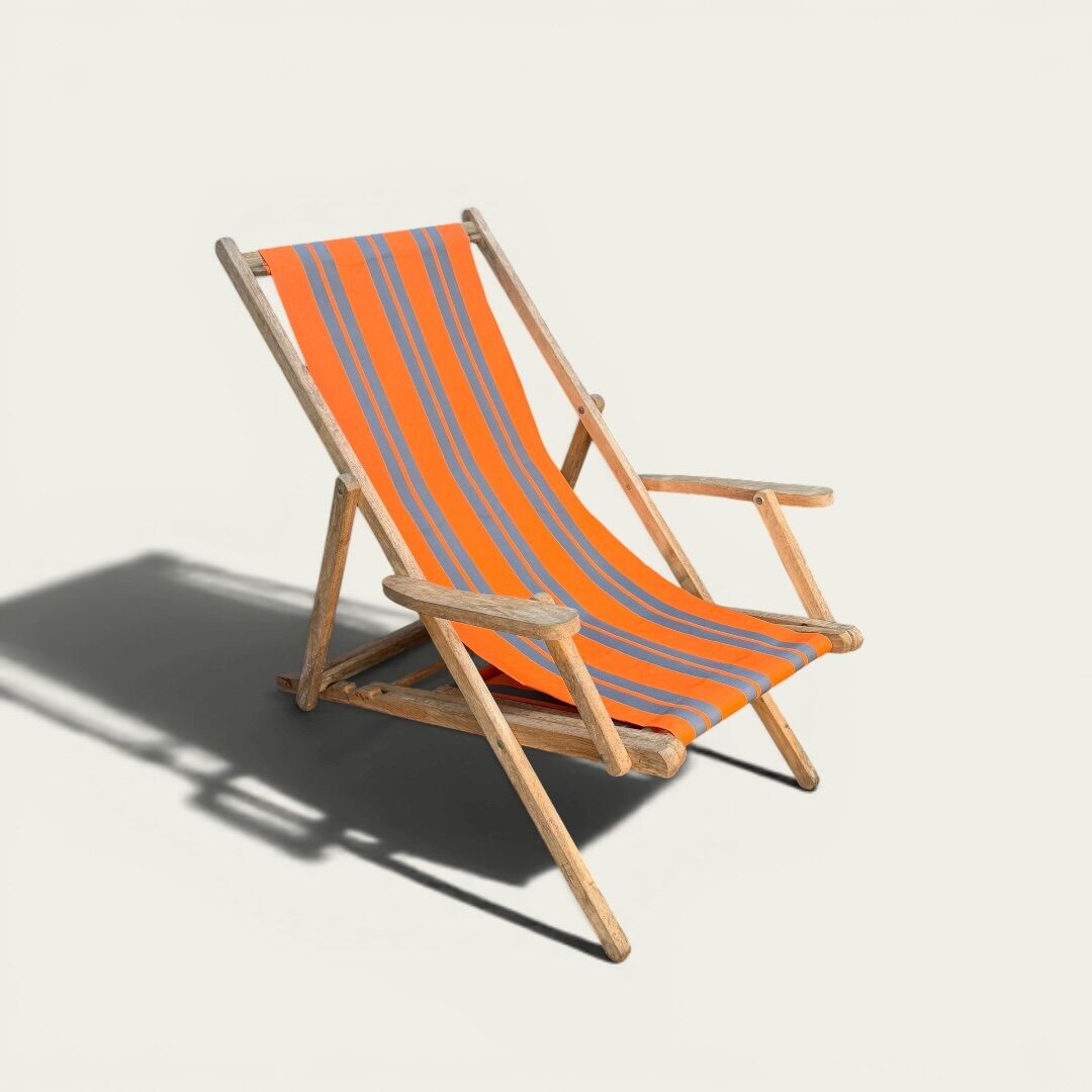 Vintage deck chair with orange and grey striped fabric, original patina.
