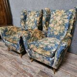Pair of vintage armchairs with enveloping backrest.