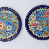 A flat bottom and two enamel bottle bottoms of Longwy