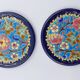 A flat bottom and two enamel bottle bottoms of Longwy