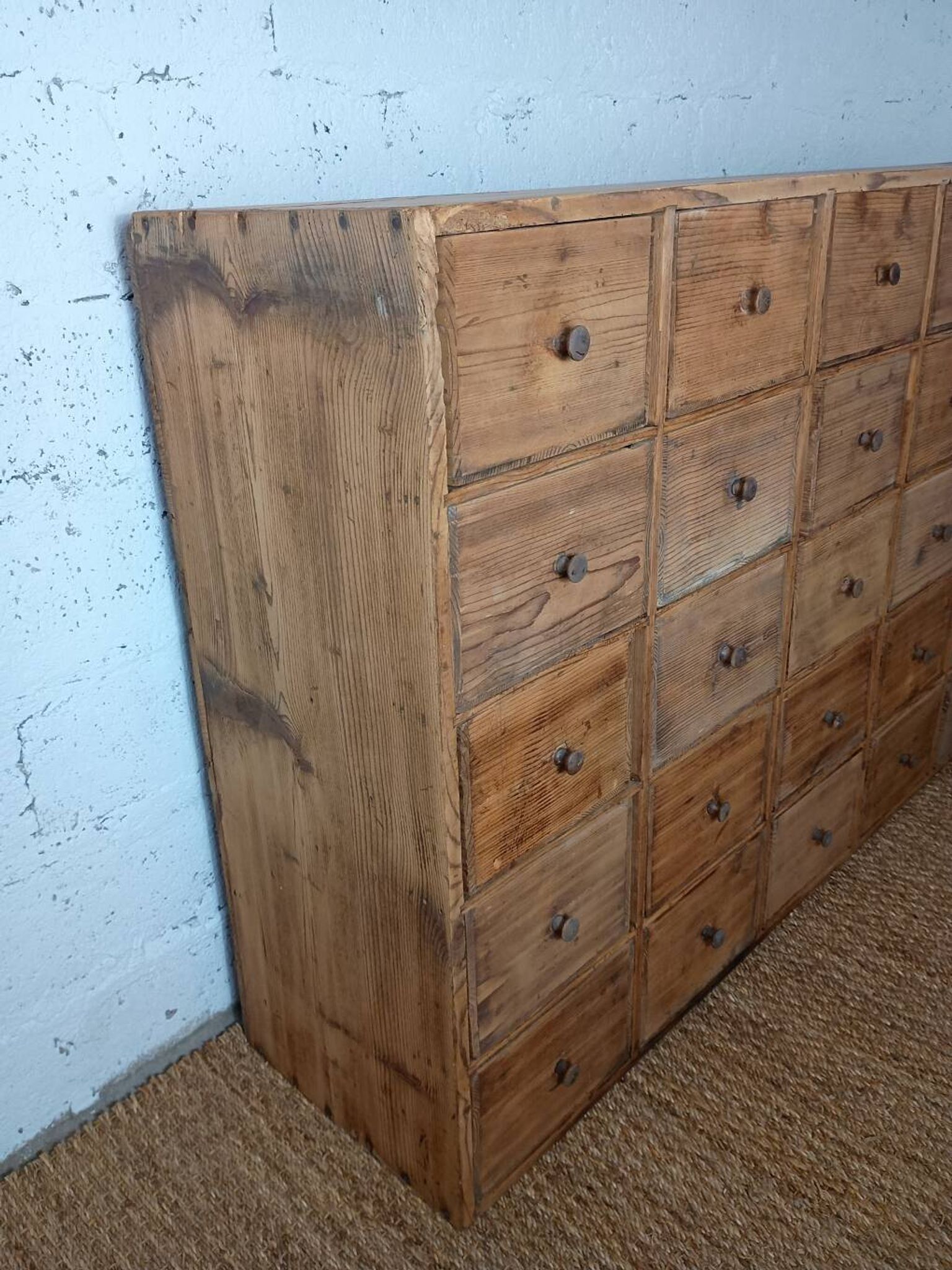 Industrial or apothecary workbench with 30 vintage wooden drawers.