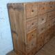 Industrial or apothecary workbench with 30 vintage wooden drawers.