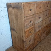 Industrial or apothecary workbench with 30 vintage wooden drawers.