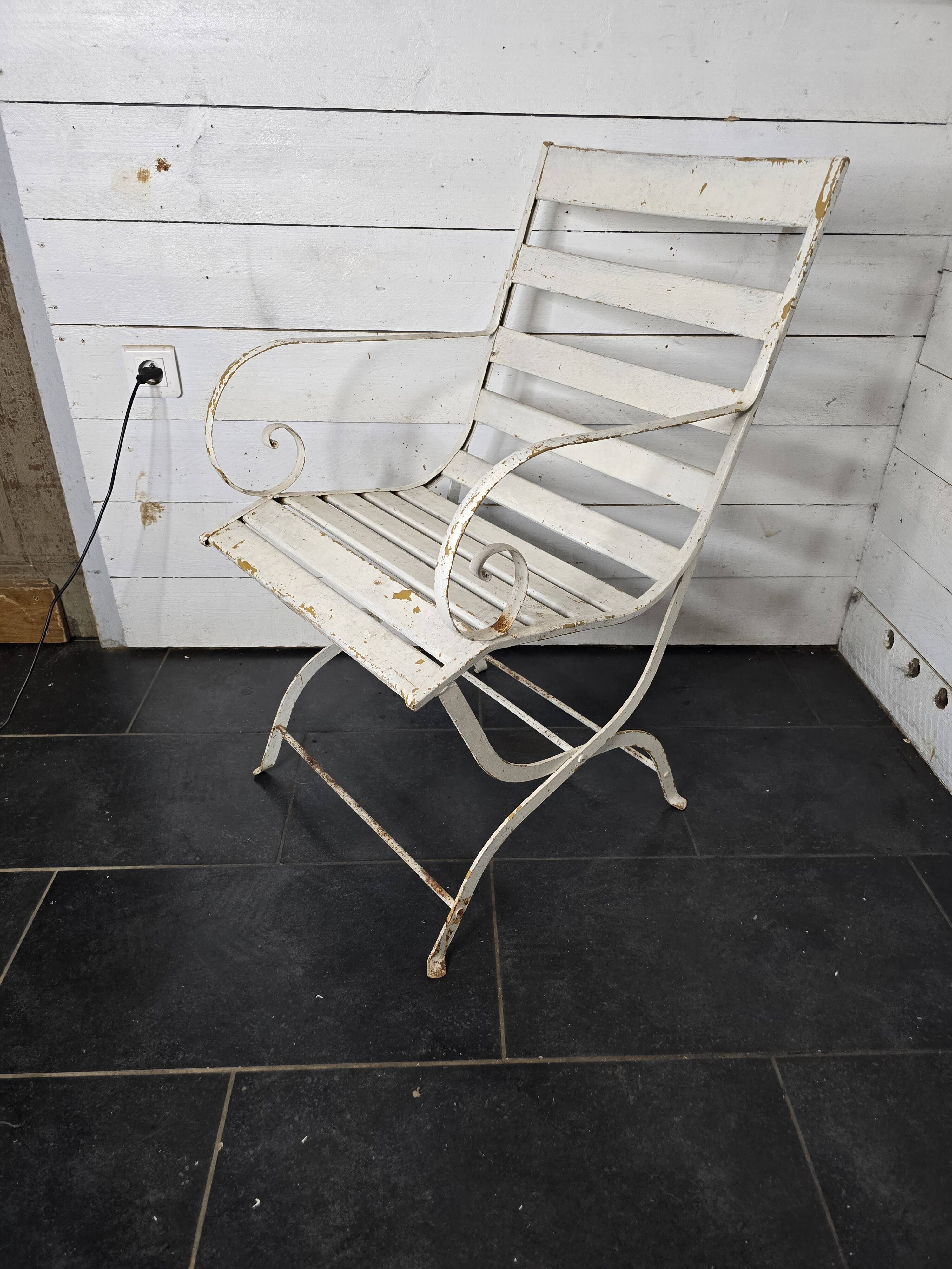 Old wrought iron and wood garden armchair