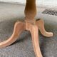 Large extendable round dining table stripped in solid cherry wood with a central leg.