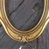 Stylized oval gold frame