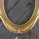 Stylized oval gold frame