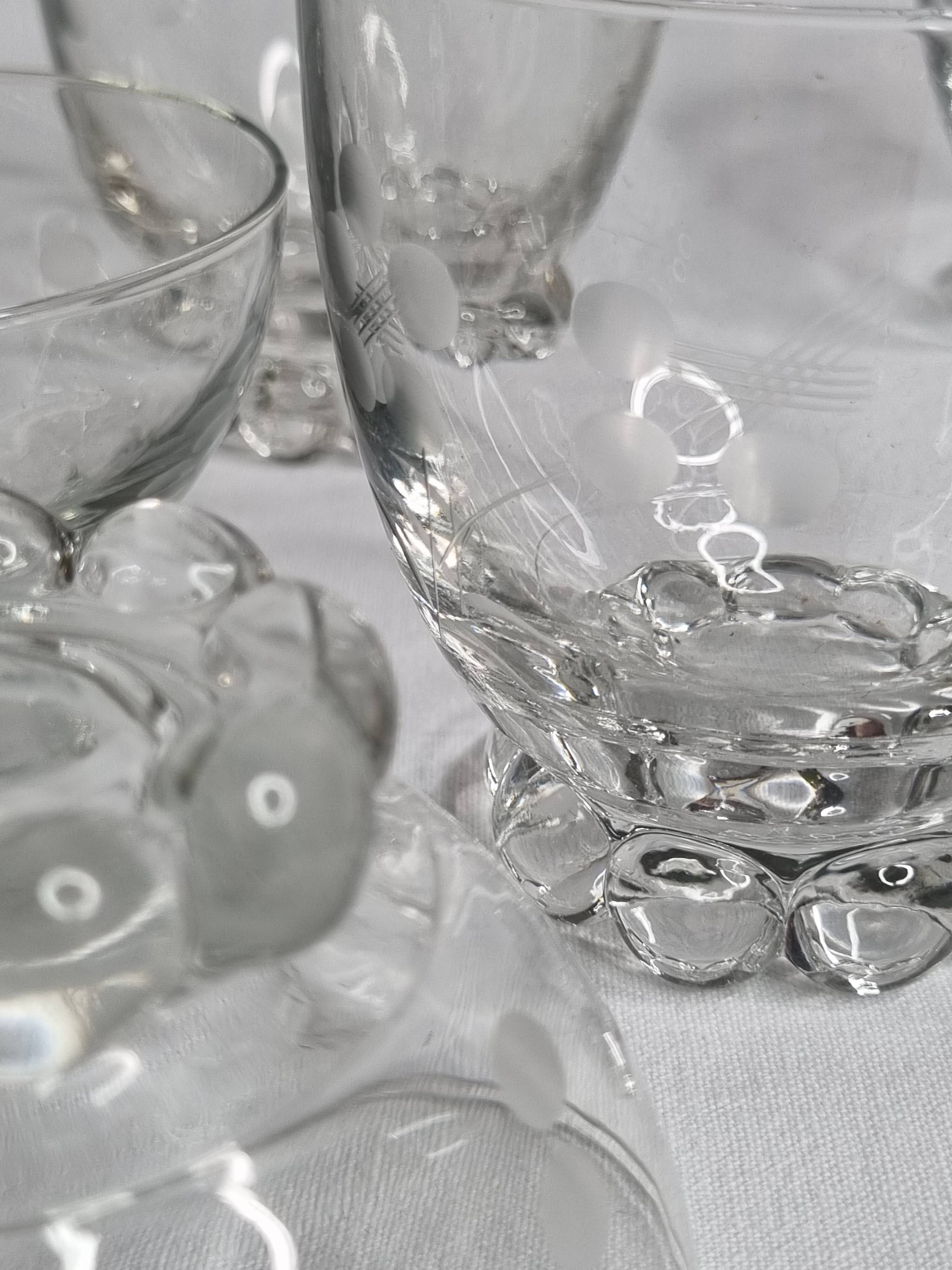 Set of Art Deco style engraved crystal bowls and glasses on spherical feet