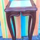 Curved leg wooden stand with a marble top.