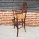 Old wooden high chair for children with straw.
