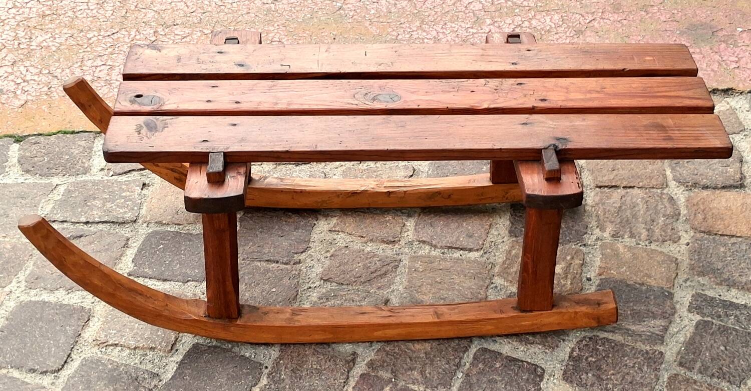 Rustic bench, old folk art, snow sled, Alps.