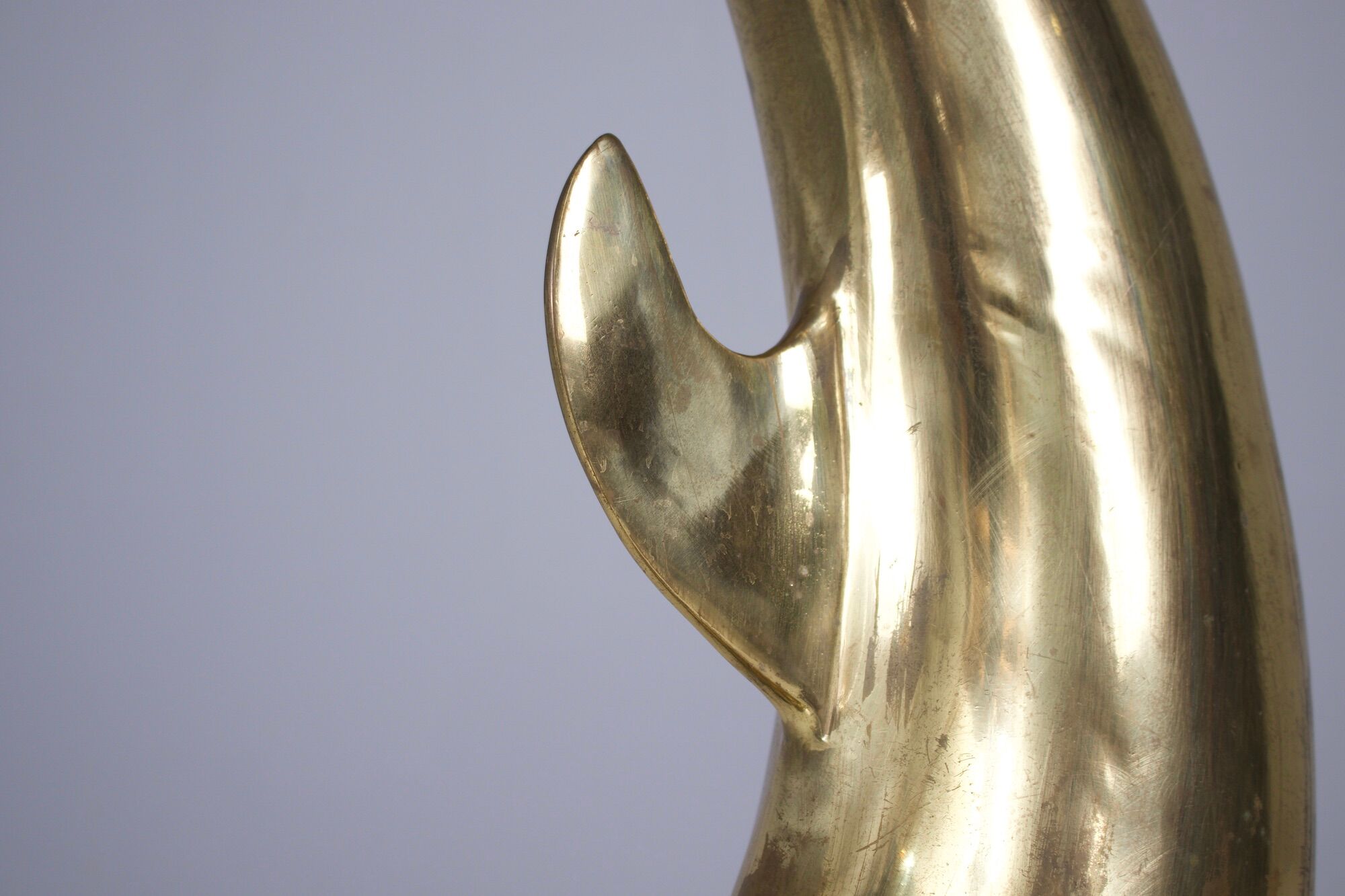 Solid brass dolphin console feet.