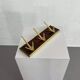 Coat rack or wall hook from the 1950s in wood and brass.