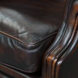 Comfortable wingback chair in English style made of cowhide leather