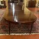 Extensible dining table from the Louis XVI period in mahogany with a banded top.