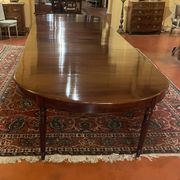 Extensible dining table from the Louis XVI period in mahogany with a banded top.