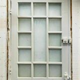 Service door with small tiles and 20th century glass impost