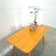 Vintage veneer table with pretty angular legs and brass at the base of the legs.