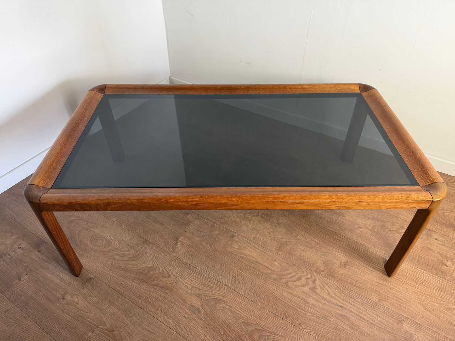 Large Scandinavian coffee table in teak and smoked glass.