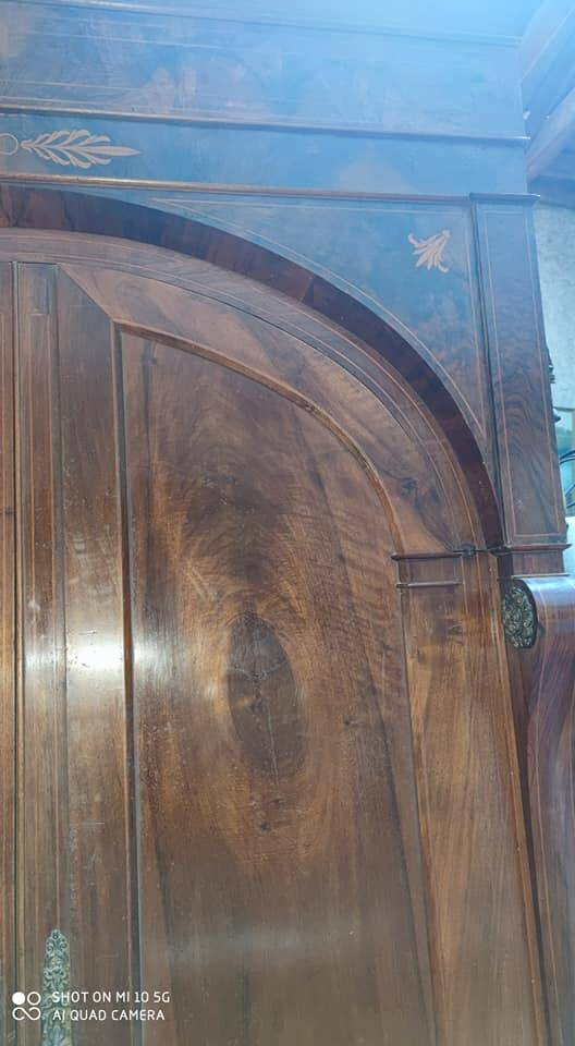 A walnut wardrobe with marquetry and boxwood stringing, dating from the Consulate period, circa 1810.