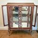 A Louis XV style display cabinet with three beechwood shelves and a white marble top.