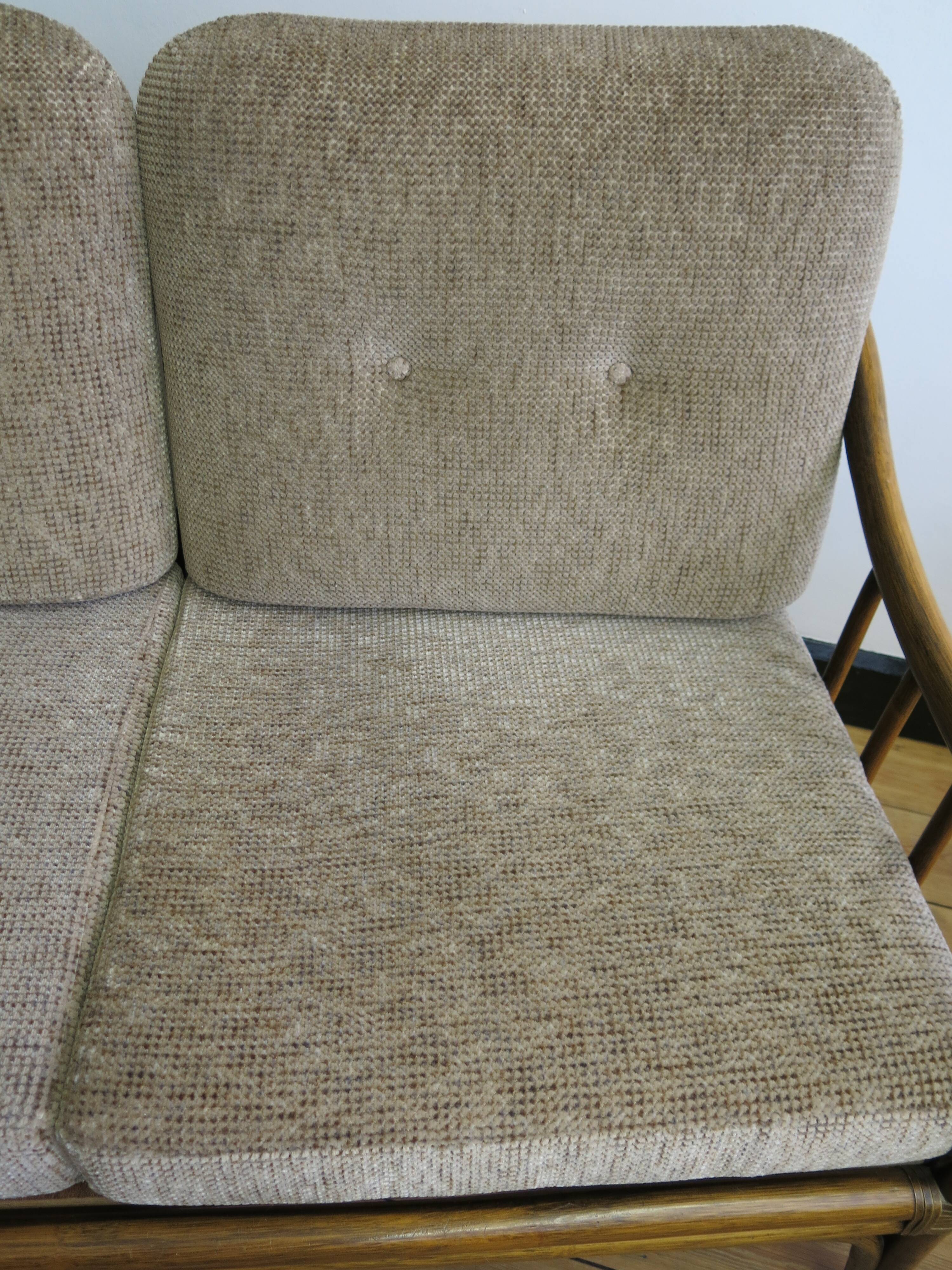 Two-seater rattan sofa with natural tones